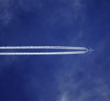 Canva - Bottom View of Plane With Contrail